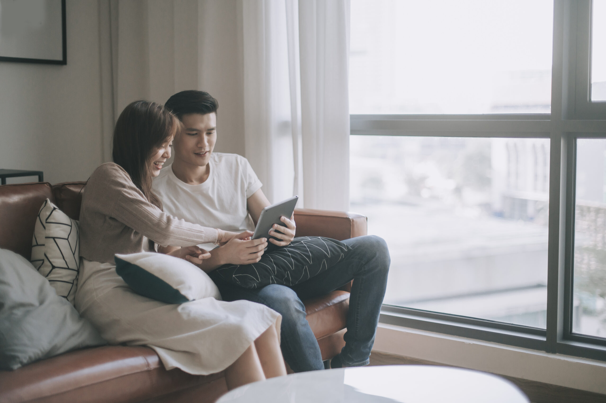 young couple spending weekend together in living room